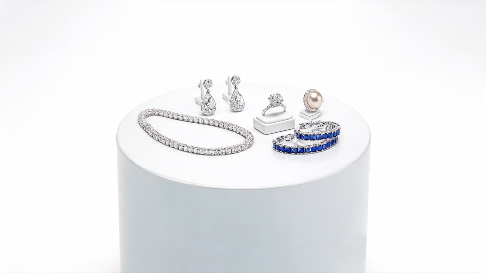 A suite of sapphire and diamond jewellery — tennis bracelet, bow earrings, pearl ring, sapphire eternity bands